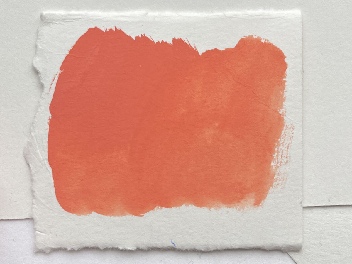 The coral red acrylic gouache when dry